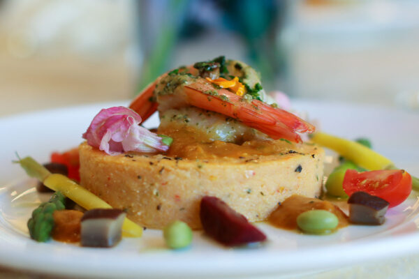 Mascarpone polenta cake with crimini mushrooms, baby carrots and asparagus topped with sautéed shrimp in red pepper pesto sauce. Drizzled with beet reduction and basil oil.