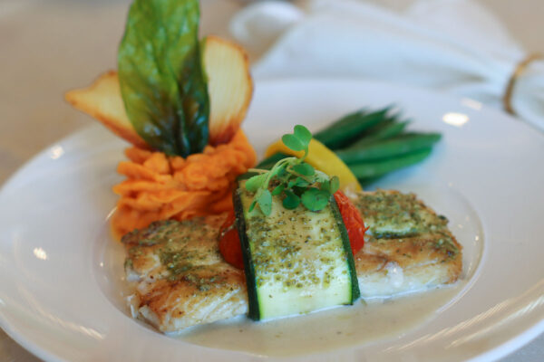 Baked mahi-mahi wrapped in roma tomato and zucchini with pipped sweet potato purée and sautéed asparagus in beurre blanc sauce.